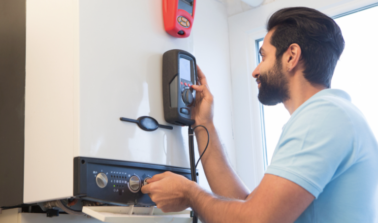 man checking old boiler for issues